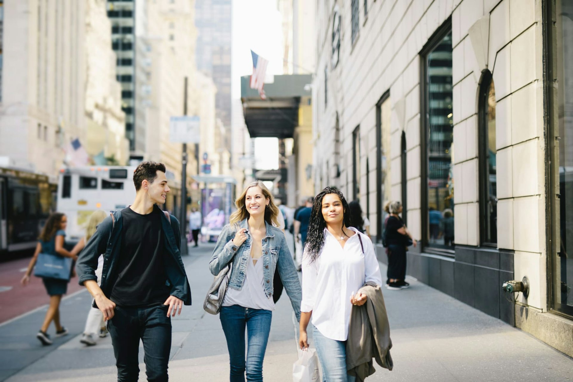 Group of people walking down sidewalk, NYC